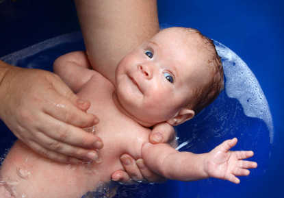 newborn baby bath in blue bathtub