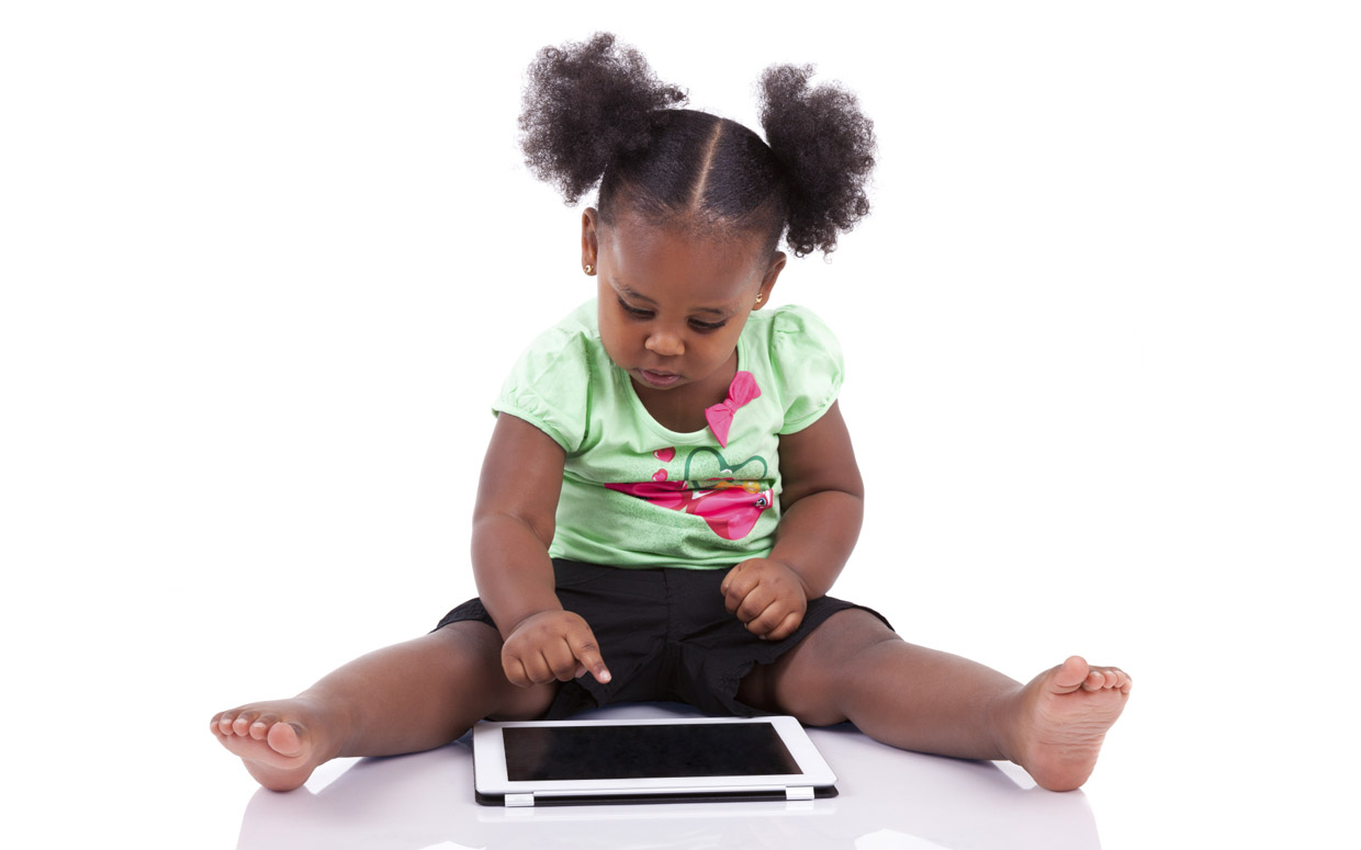 Little african american girl using a tablet pc, isolated on white background